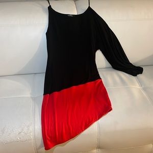 A twist to the little black dress! A pop of red is perfect! asymmetric design